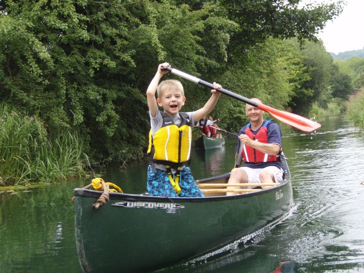 two people in a canoe with paddles on the water