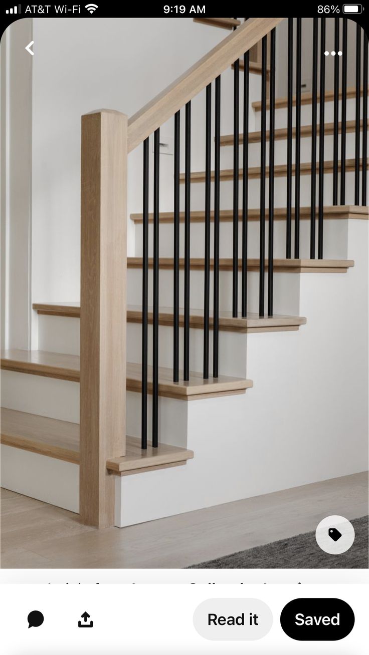 a staircase with black and white railings next to a carpeted floor in an empty room