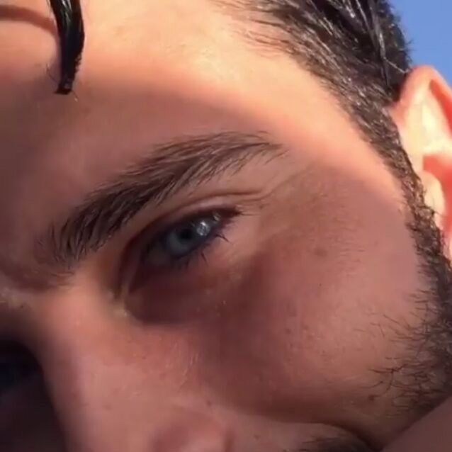 a close up of a man's face with ear piercings on his ears