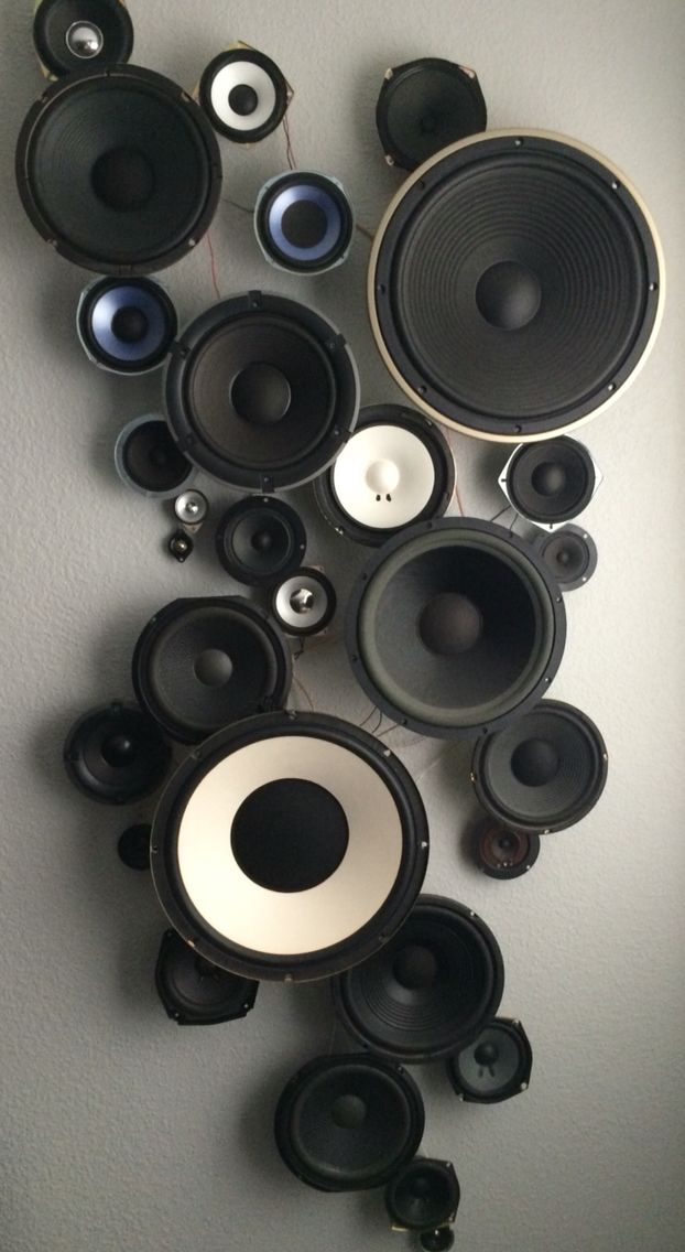 many different speakers are arranged on the wall