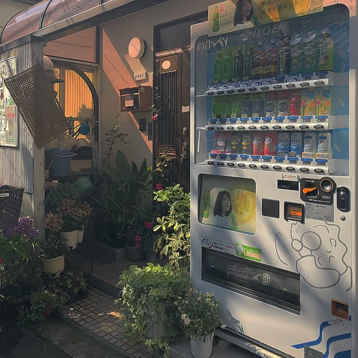 a vending machine in front of a store filled with plants and water bottles on display