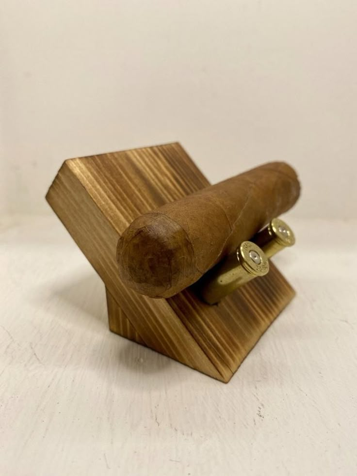 a small wooden object on a white surface