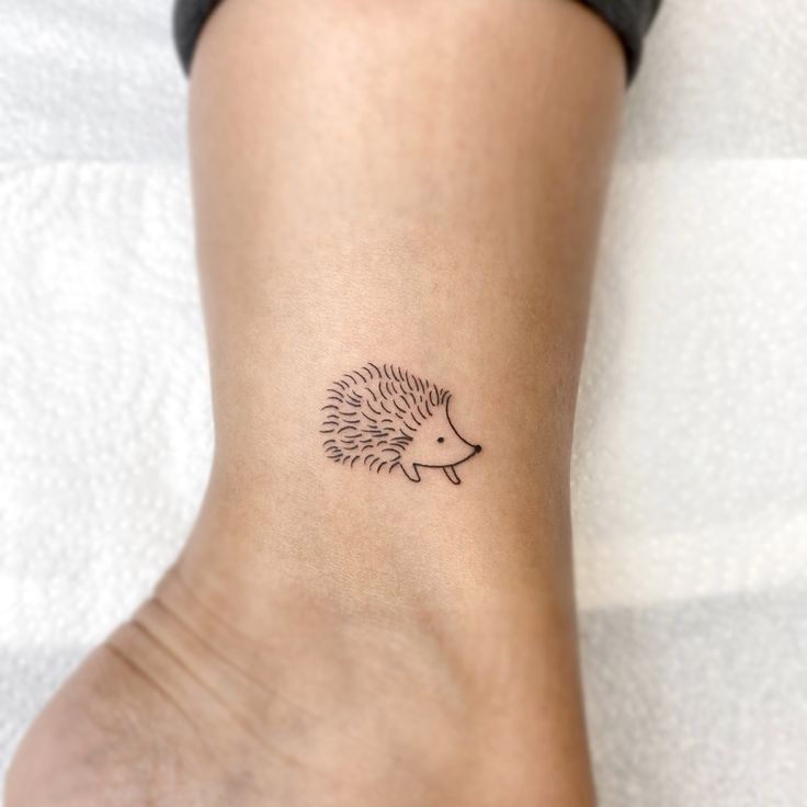 a small hedgehog tattoo on the ankle