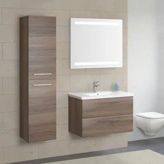 a white toilet sitting next to a bathroom sink under a mirror and a wooden cabinet