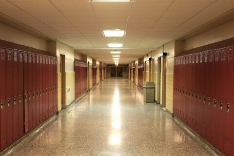 an empty hallway with red lockers in the middle stock photo - image 399784