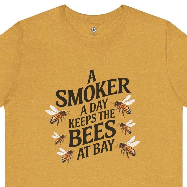 A fun t-shirt for beekeepers and bee lovers alike featuring the quote 'a smoker a day keeps the bees at bay'. This t-shirt exudes a whimsical and light-hearted vibe, perfect for casual wear or as a statement piece for bee-related events and celebrations. Ideal for those passionate about beekeeping and nature. Product features - Side seams for shape retention and structural support - Ribbed knit collar with seam for elasticity and shape retention - Shoulder tape for stabilizing and preventing str Bee Keeping, Shirt Price, Unisex Shirt, Cool T Shirts, San Jose, Statement Pieces, Ribbed Knit, Gender Neutral, Bee