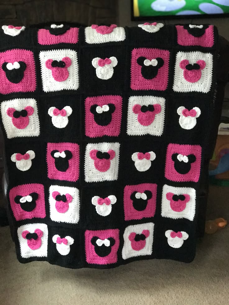 a crocheted blanket with minnie mouse ears on it