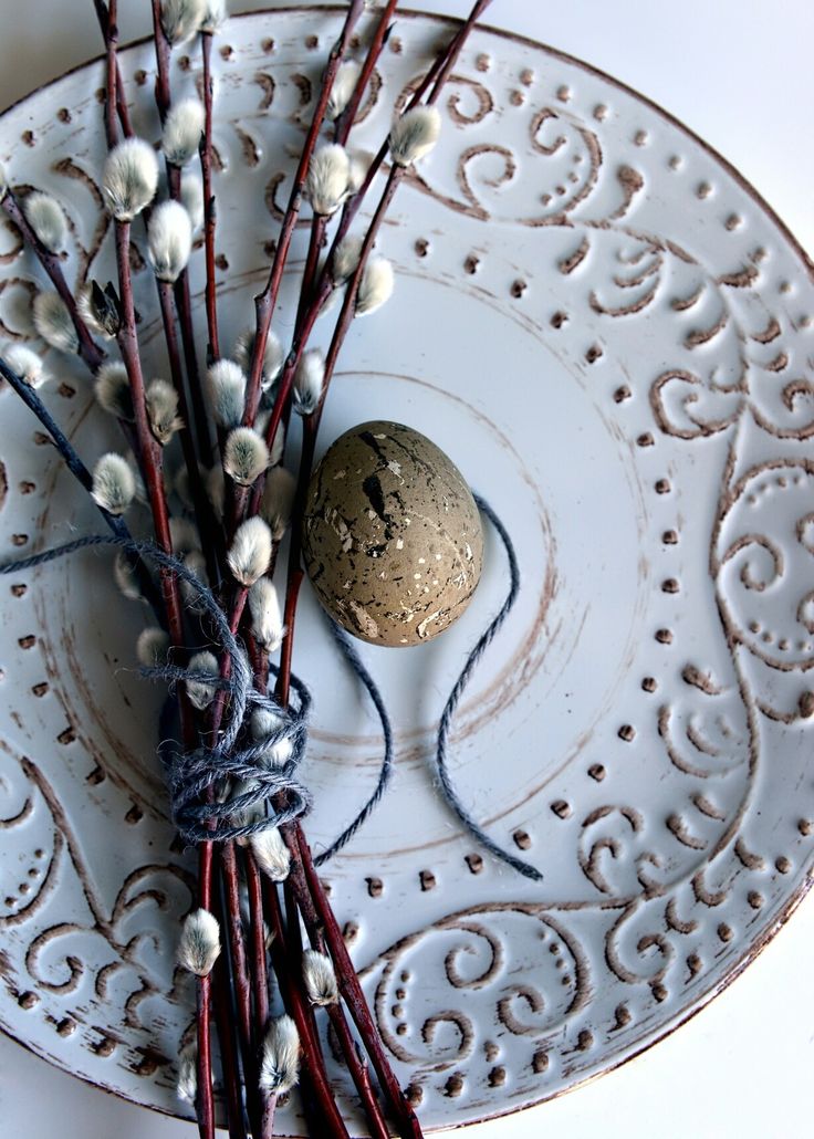 a white plate topped with branches and a rock