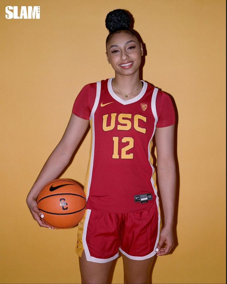 a woman in red uniform holding a basketball