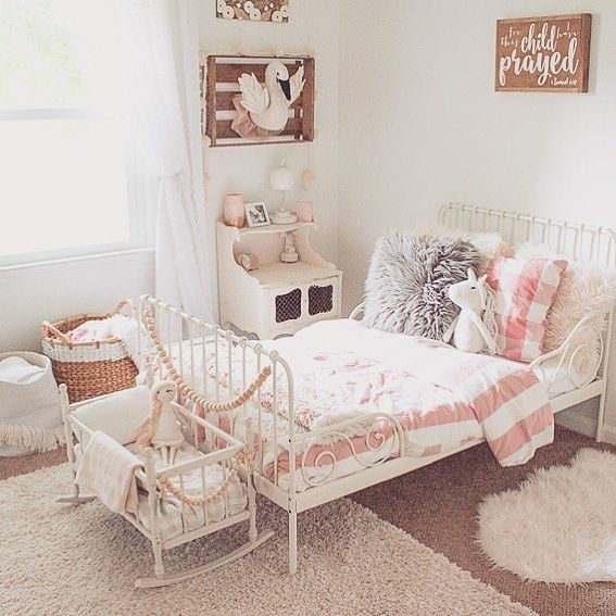 a white bed sitting in a bedroom on top of a floor next to a window