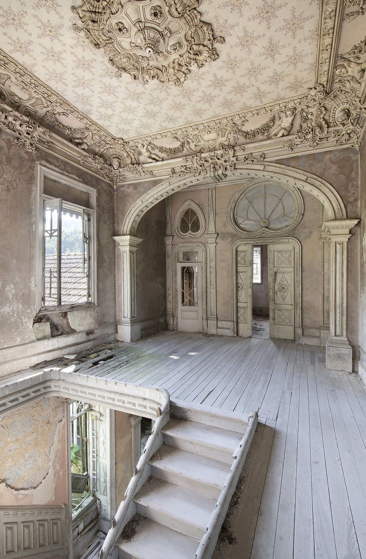 an empty room with stairs leading up to the second floor