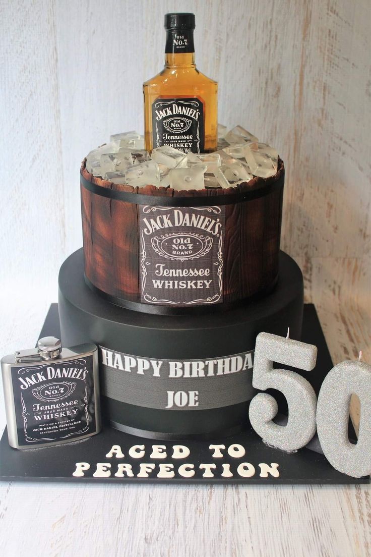 a 50th birthday cake with liquor bottles and ice