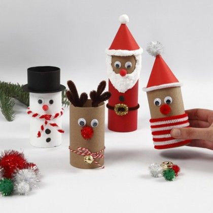 a hand is holding an item made out of toilet paper and some other items that look like christmas decorations