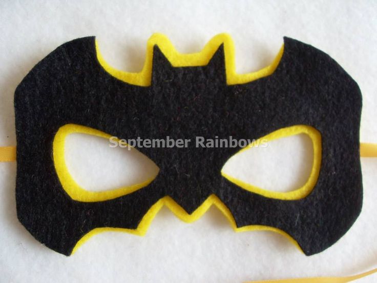 a felt batman mask with yellow and black accents