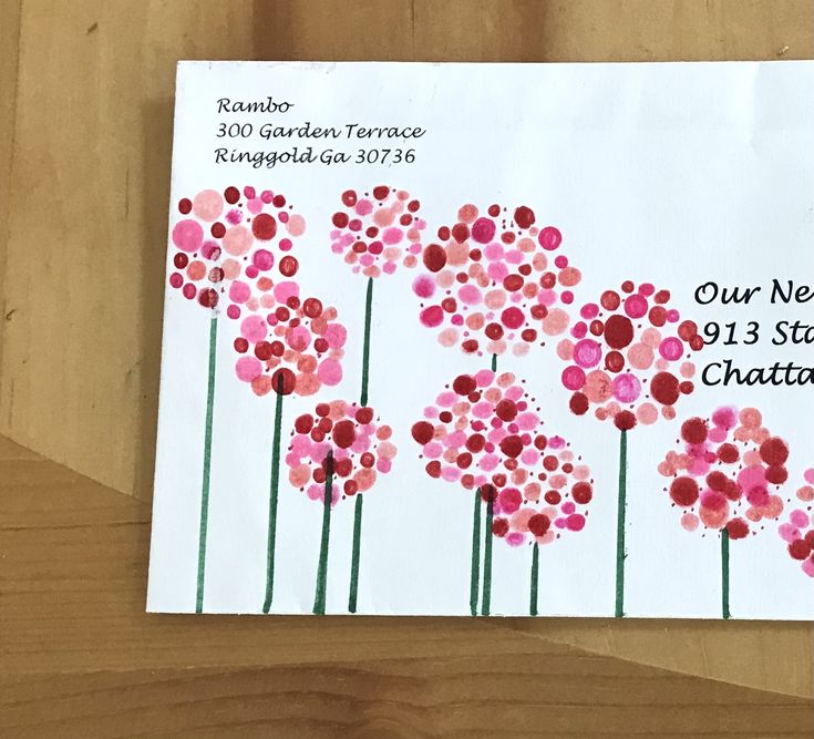 a close up of a postcard on a table with flowers painted on it and the words our new year's greeting