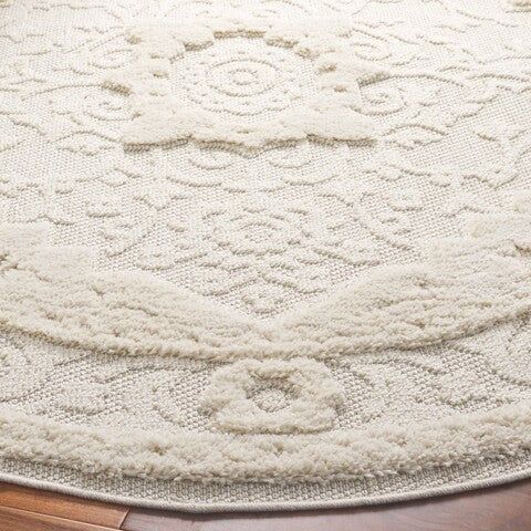 a large white rug on top of a wooden floor