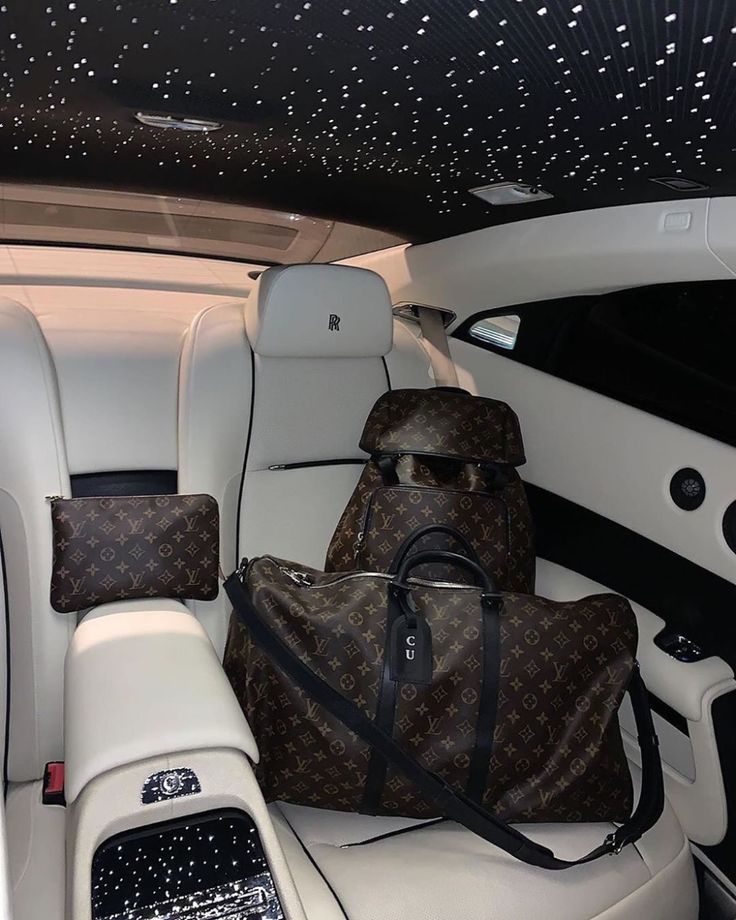 two bags sitting in the back seat of a car with stars on the ceiling above them