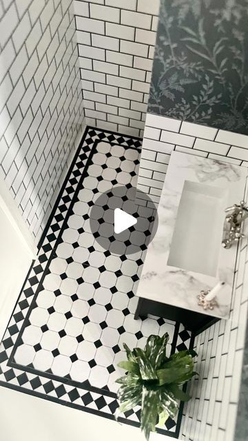 a bathroom with black and white tiles on the floor