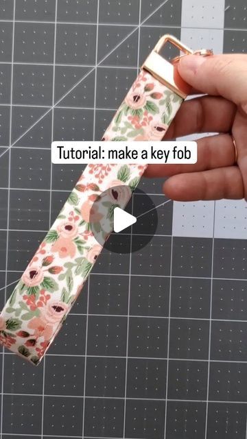 a person is holding an apple watch band with flowers on it and the text, how to make a key fob