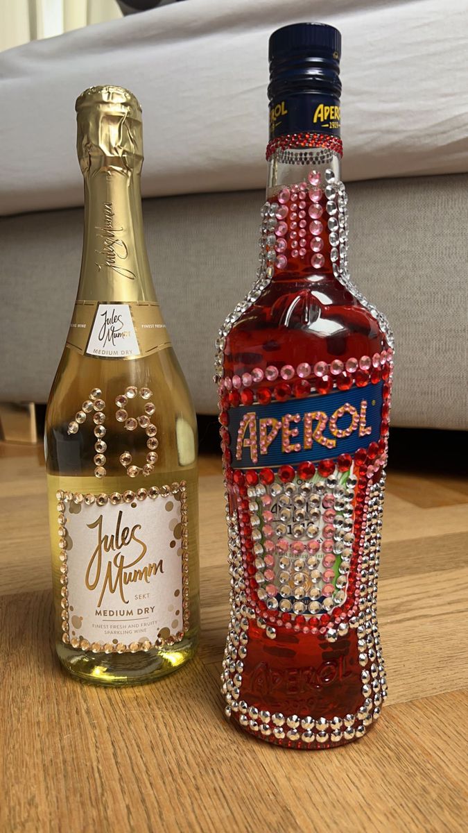 two bottles of wine sitting on top of a wooden table