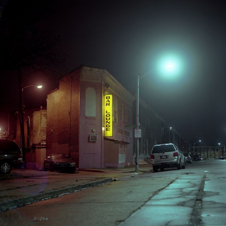 a car is parked on the street at night