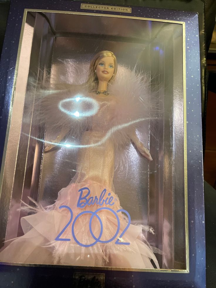 a barbie doll in a display case with the number 20 on it's back