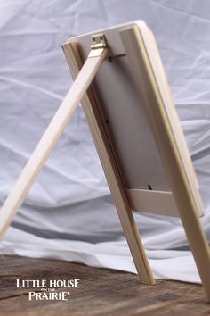 a wooden easel sitting on top of a table