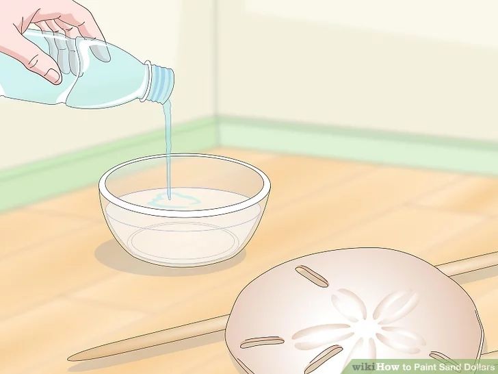 a person pouring water into a bowl on the floor next to a whisk