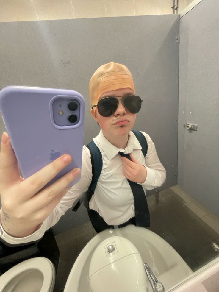 a person taking a selfie in front of a mirror