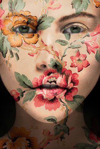 a woman with flowers painted on her face