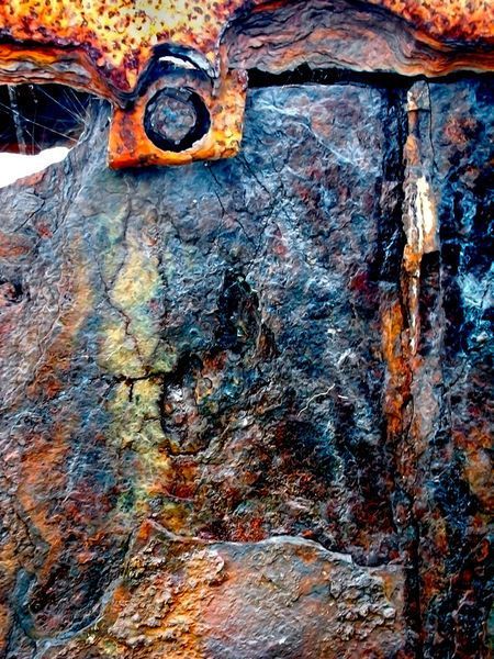 an old rusted metal door with holes in the middle and rusty paint on it