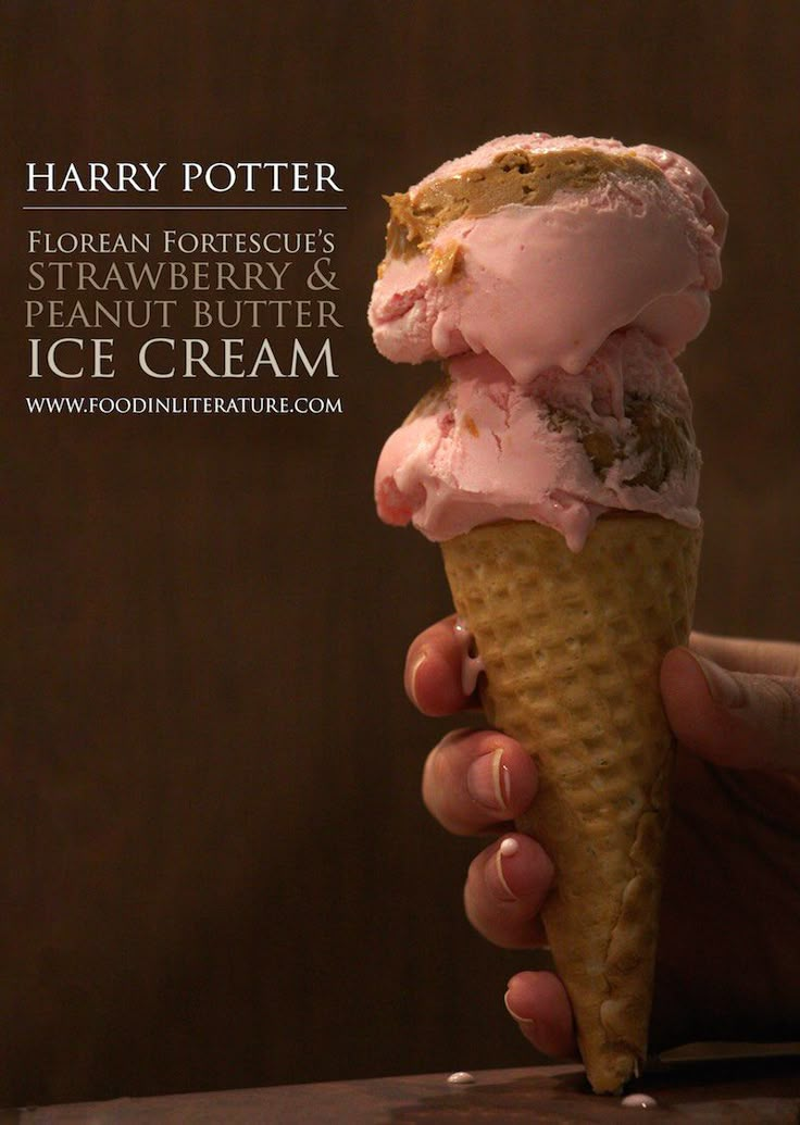 a hand holding an ice cream cone with pink icing