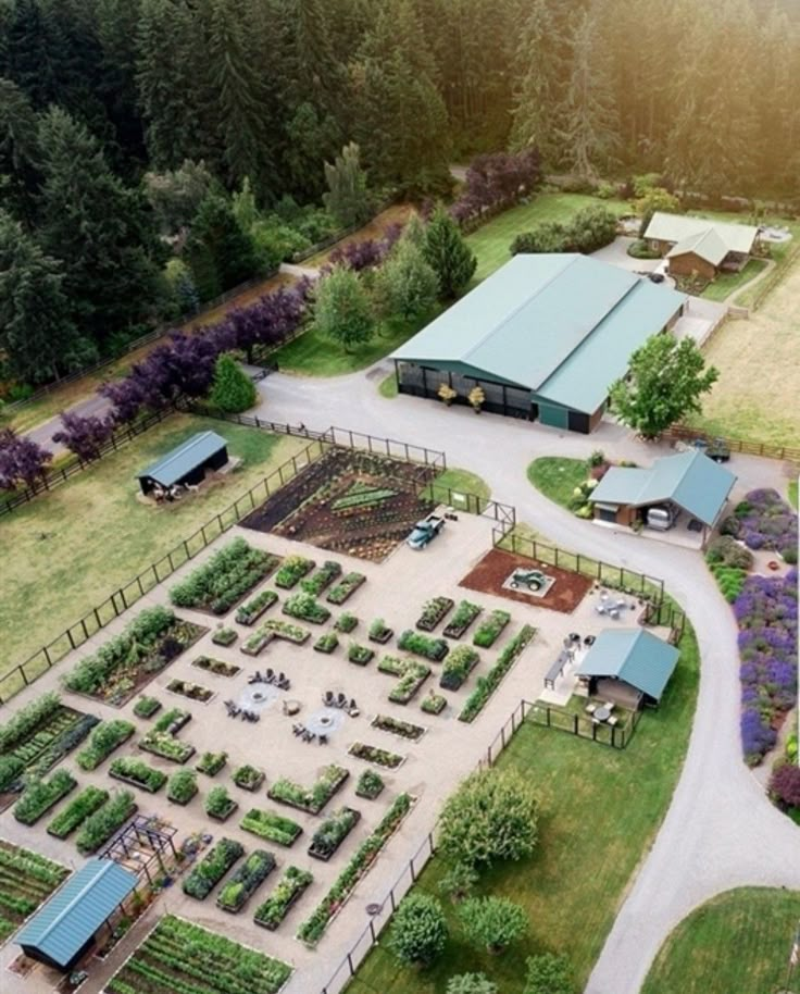 an aerial view of a farm with lots of trees and plants in the middle of it