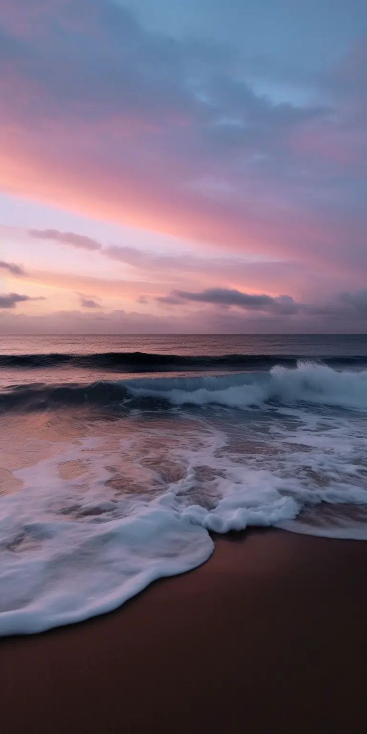 the sun is setting at the beach with waves coming in to shore and pink clouds