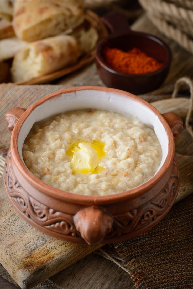 a bowl of oatmeal with an egg in it on a wooden table