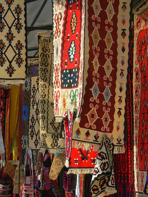 carpets and rugs for sale at an outdoor market