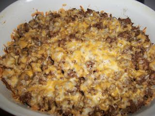 a casserole dish with cheese and ground beef