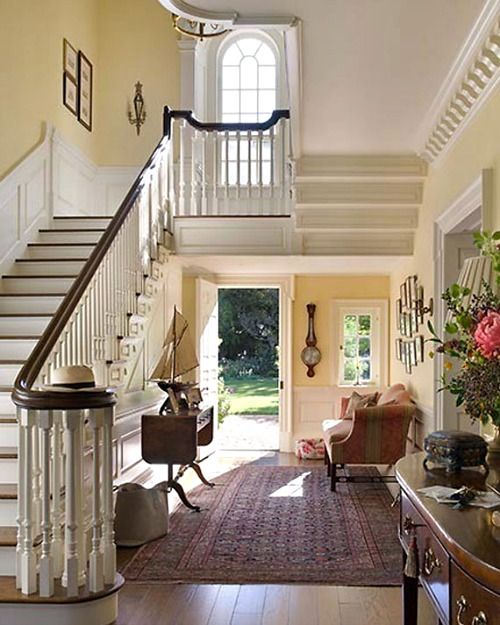 an entryway with stairs leading up to the second floor and another room on the other side