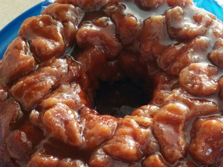 a bundt cake covered in caramel glaze on top of a blue plate