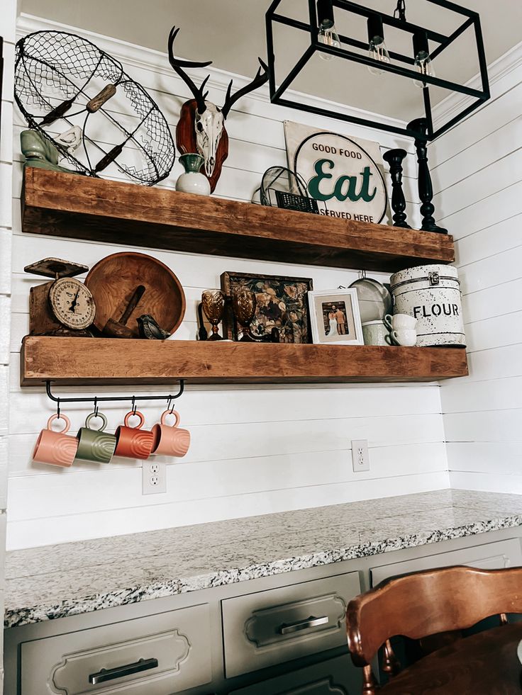 the shelves in the kitchen are filled with various items and decor, including deer heads