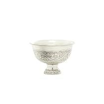 a white bowl with an ornate design on the rim and base, sitting on a white surface