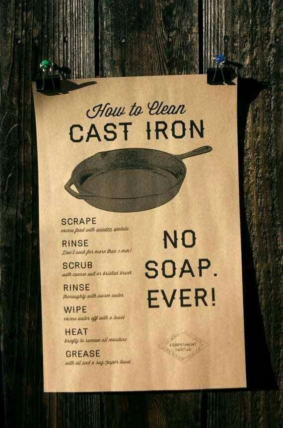 a sign on a wooden fence that says how to clean cast iron no soap ever