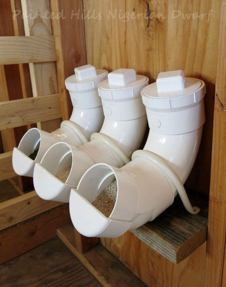 four white rain boots hanging from the side of a wooden wall