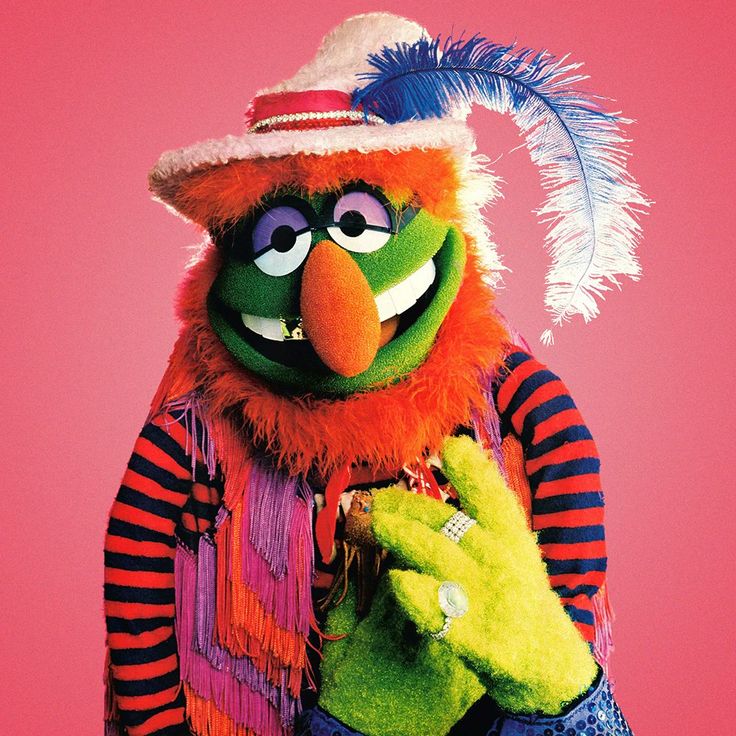 the muppet is dressed in colorful clothing