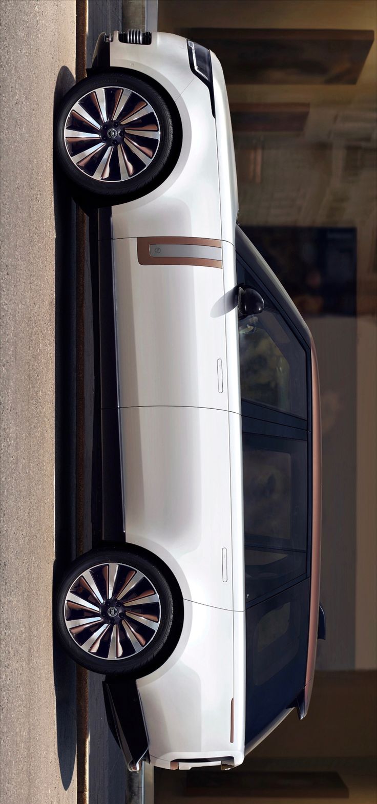 an overhead view of a white car parked in front of a building