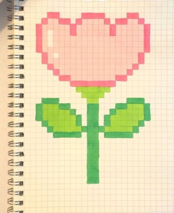 a drawing of a pink flower on top of a white notebook with the words pixel art written in it