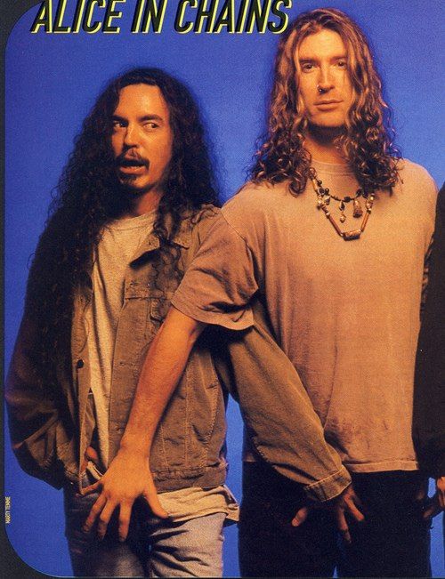 two men standing next to each other in front of a blue background with the words alice in chains on it