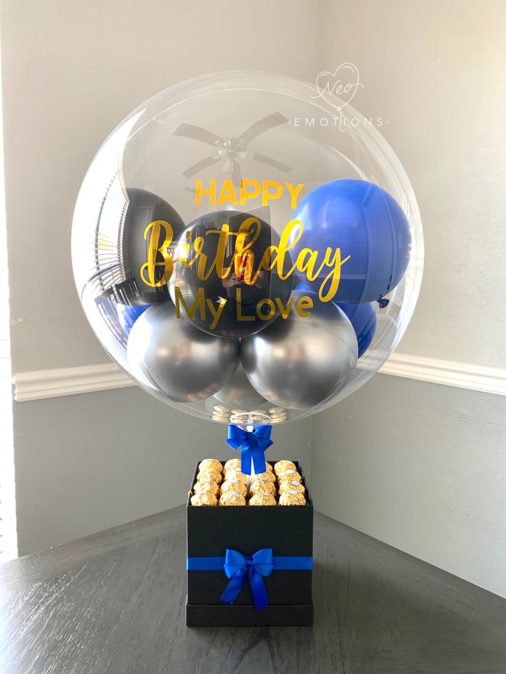 a birthday balloon in a box filled with balloons