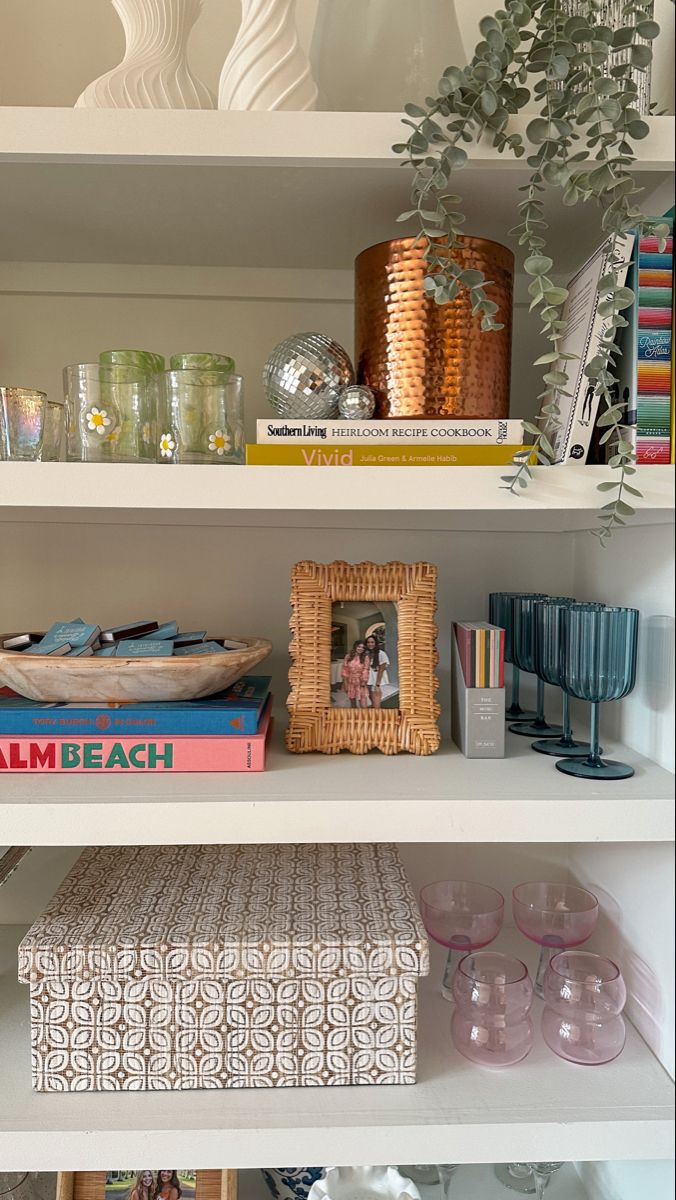 the shelves are filled with books, vases and other decorative items on top of them