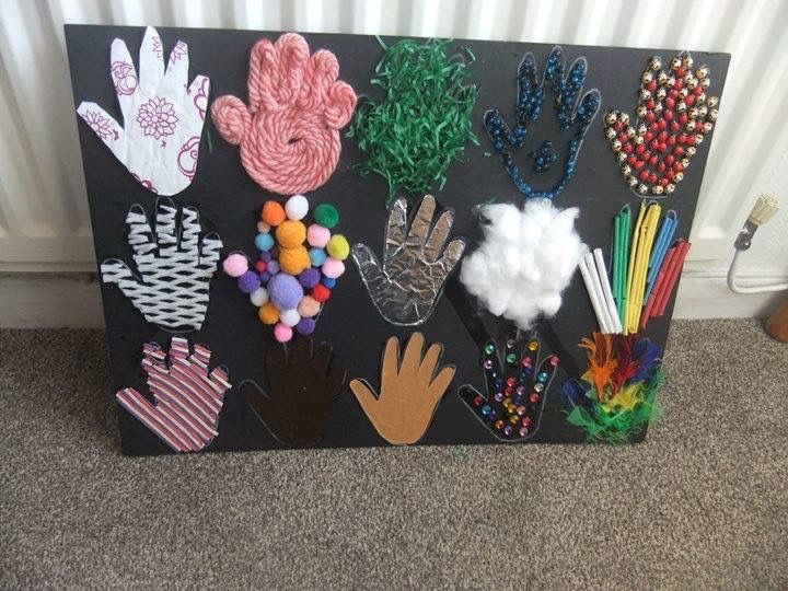 a black board with lots of different handprints on it and some balls in the middle